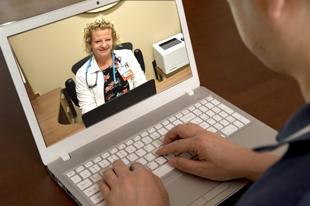 a doctor who is remotely consulting with a patient.