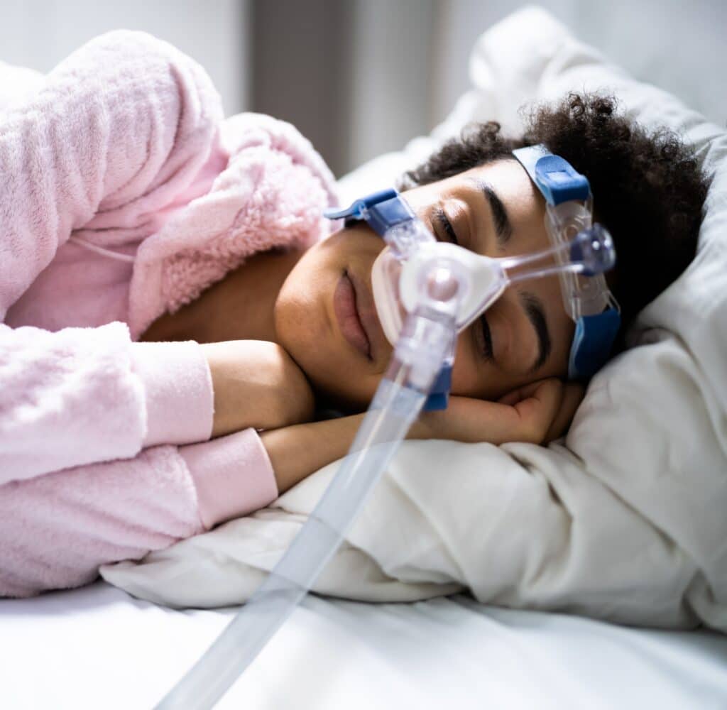 sleeping woman with CPAP